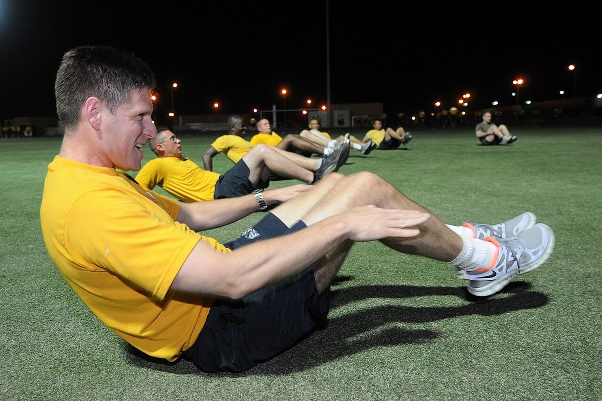 Assistant Secretary of the Navy for Manpower and Reserve Affairs Juan M. Garcia performs in-and-outs during an early morning physical traini