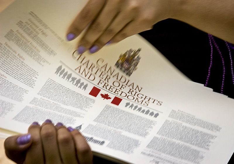 Distributing copies of the Canadian Charter of Rights and Freedoms.