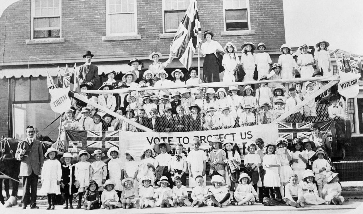 Hillhurst Presbyterian Sunday school group promoting prohibition / temperance, Calgary, Alberta. In anti-liquor campaign. Large buildings to