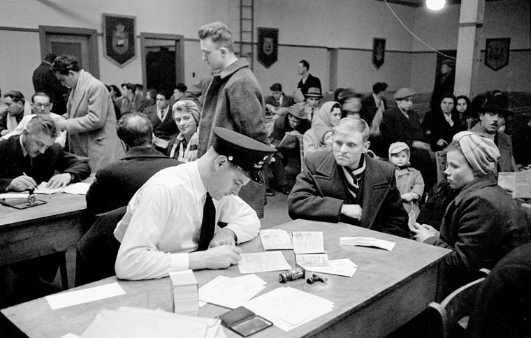 Examining new arrivals in the Immigration Examination Hall, Pier 21, Halifax, Nova Scotia, Canada.