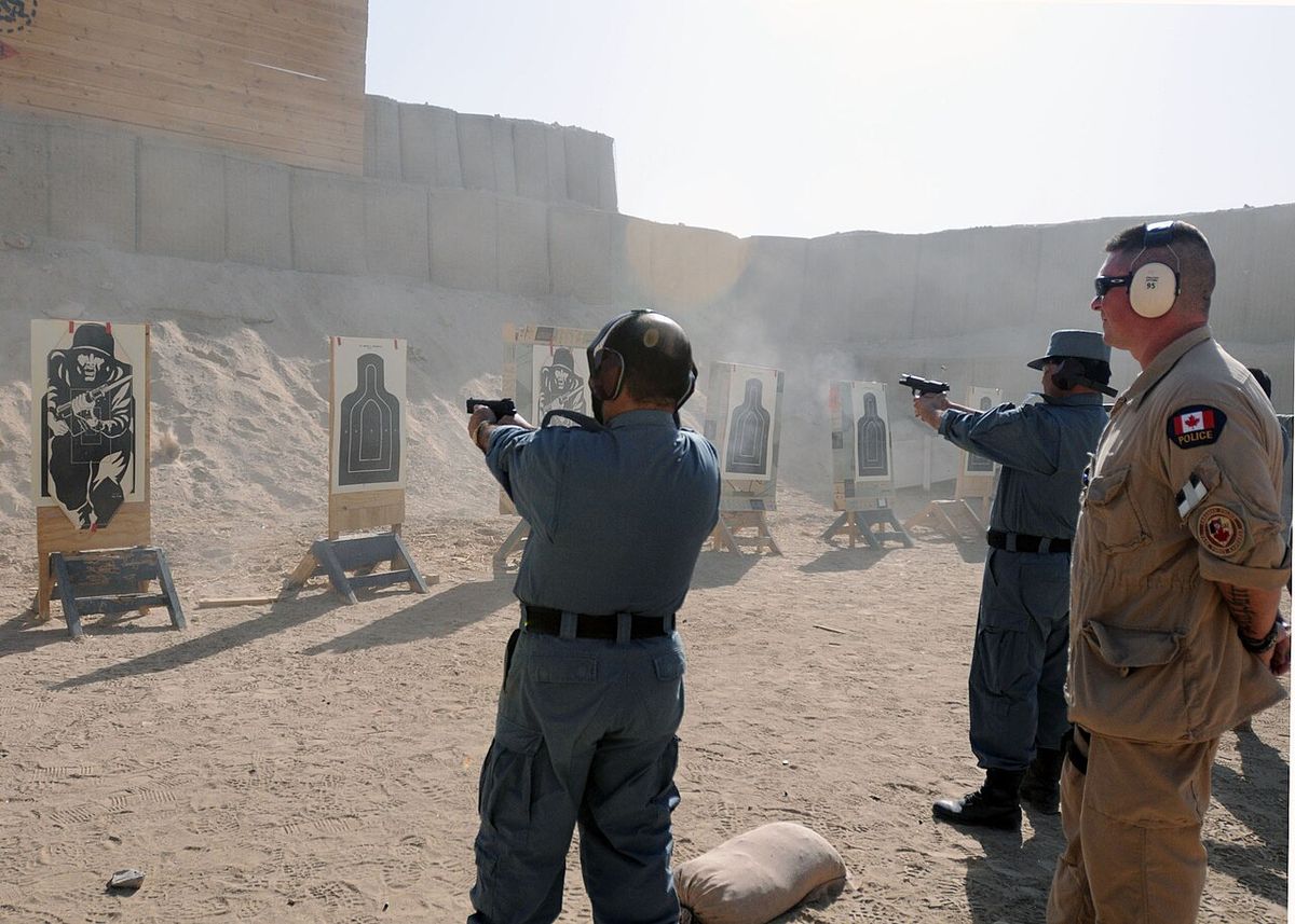 Constable Lorant Haged, Royal Canadian Mounted Police and instructor at the leadership and management course, observes ANP as they shot at t