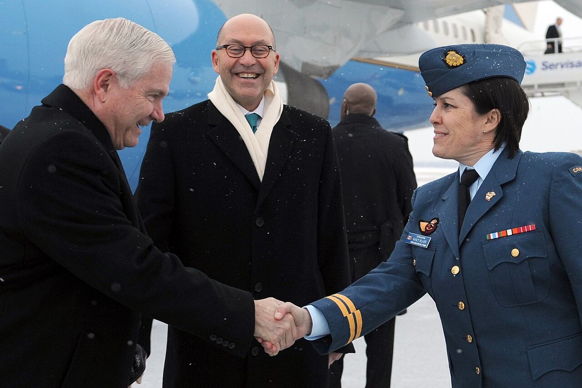 Secretary of Defense Robert M. Gates, left, shakes hands with Royal Canadian Air Force Capt. Nancy Silver upon his arrival in Ottawa, Canada