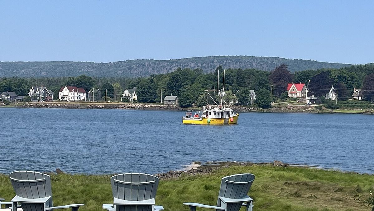 Fishing boat harvesting lobster traps in Annapolis Royal harbour