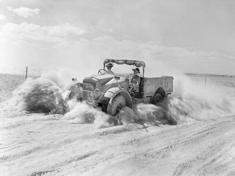 A British Army 15-cwt truck throws up a cloud of sand and dust while moving at speed along a desert track in North Africa, 1 November 1940. 