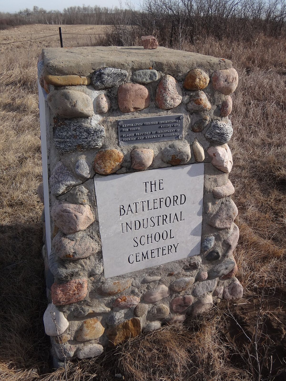 A cairn erected at the Battleford Industrial School in Battleford, Saskatchewan, Canada. This cairn was placed in 1975 after a total of 72 g