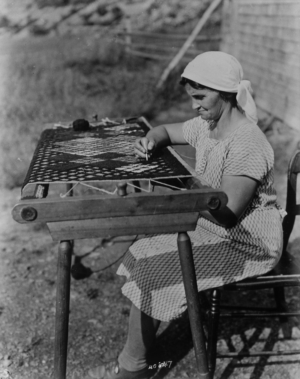 Acadian lady making a rug, 1938. Cape Breton, Nova Scotia, Canada. Reference No. / Numéro de référence : MIKAN 3353841 collectionscanada.gc.