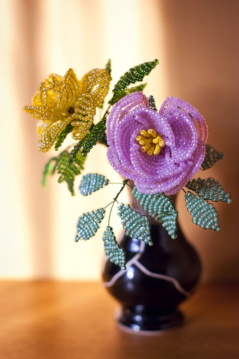 Two beaded roses in a vase - a "French beaded" yellow rose on the left and "Victorian beaded" pink rose