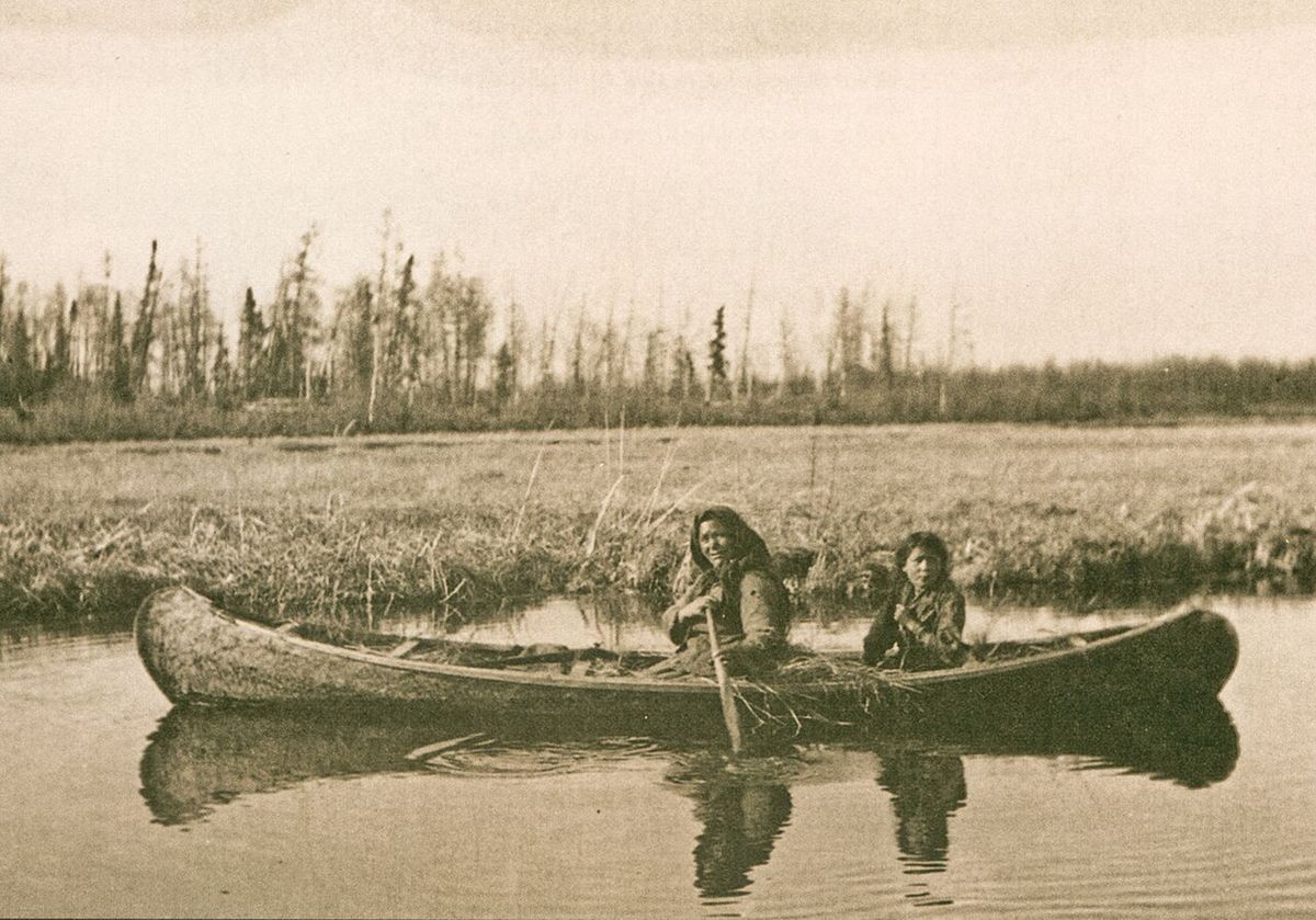 A Chipewyan woman and child set out to hunt muskrat along the shallow margins of Garson Lake in western Saskatchewan.