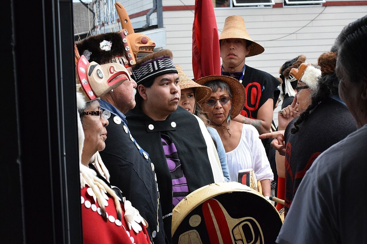 Haida wait for their Heiltsuk hosts to welcome them to dance and sing at a peace potlatch in Waglisla.