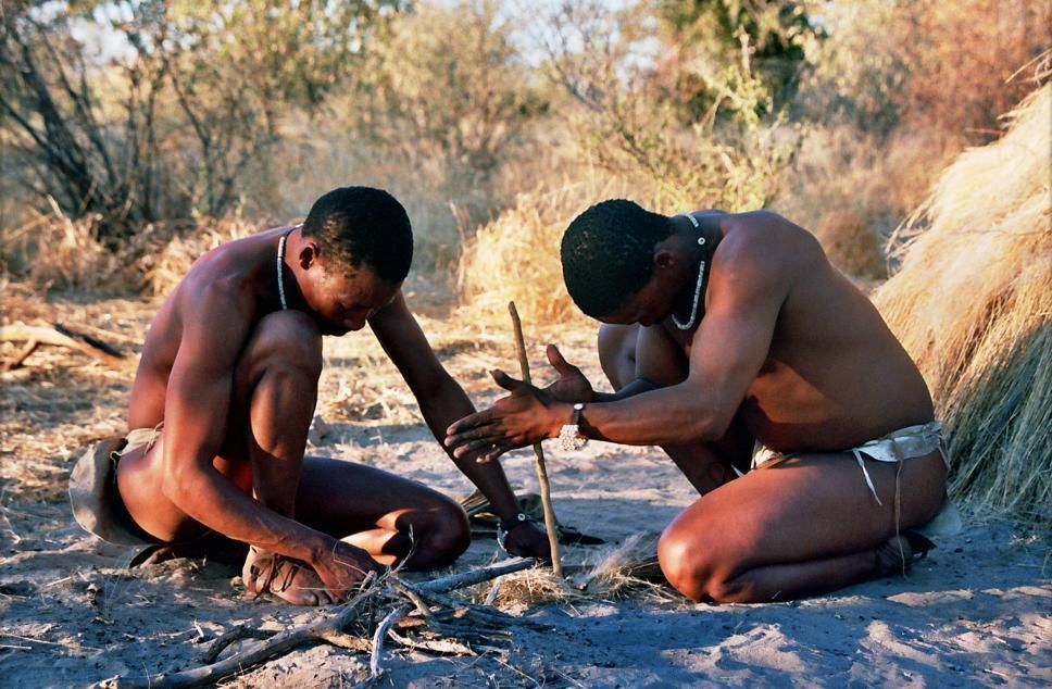 Bushmen in Deception Valley, Botswana demonstrating how to start a fire by rubbing sticks together.