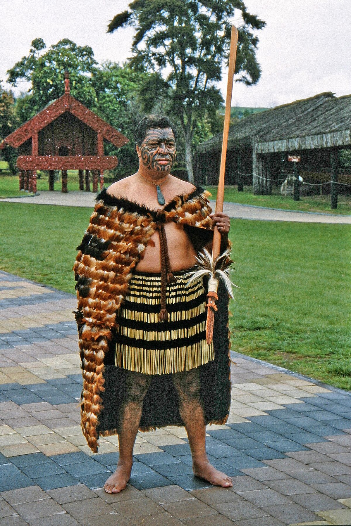 Maori (Māori) with the original chief's clothing made of feathered bird skin and with Maori tattoos on the face. Seen in Rotorua, New Zealan