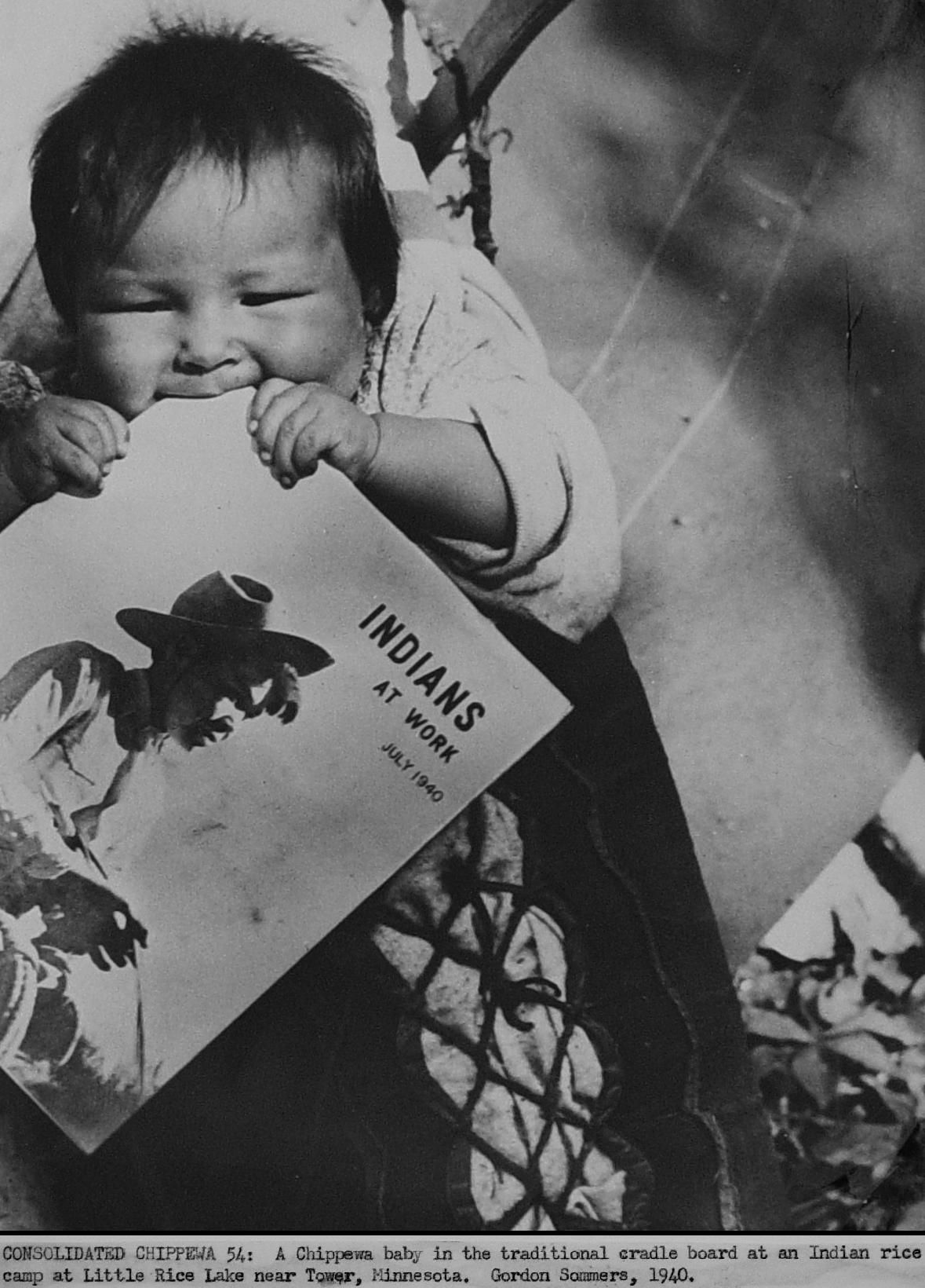 1940 US government publicity photo meant for newspaper and magazine publication: Minnesota farm worker scene of Chippewa baby (at a rice fie