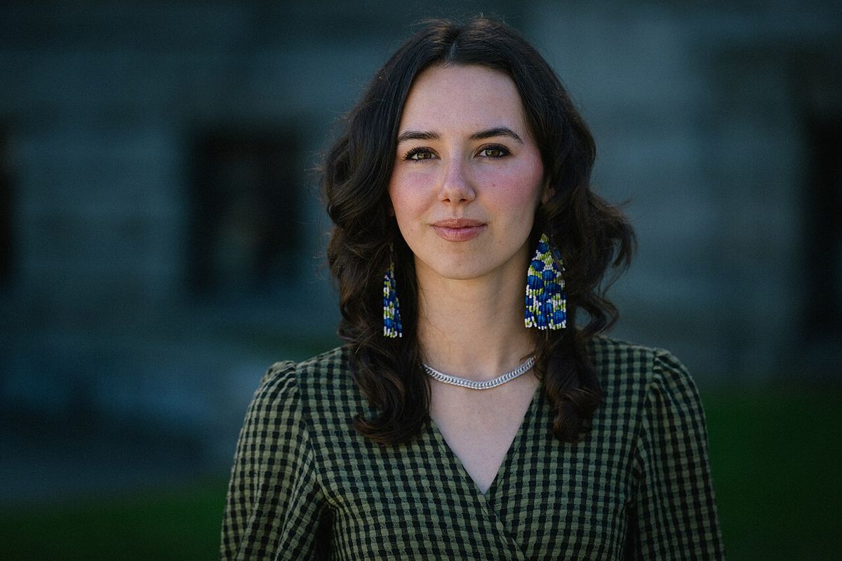 A head-and-shoulders portrait of Emily Lowan, Leader of the BC Greens, photographed in soft natural light in front of the BC Parliament Buil