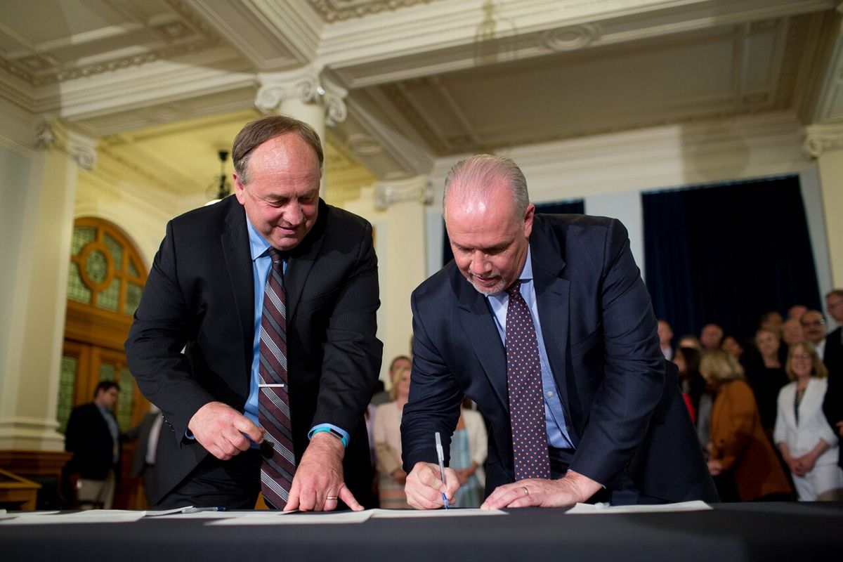 John Horgan and Andrew Weaver sign the coalition agreement, Victoria, BC.